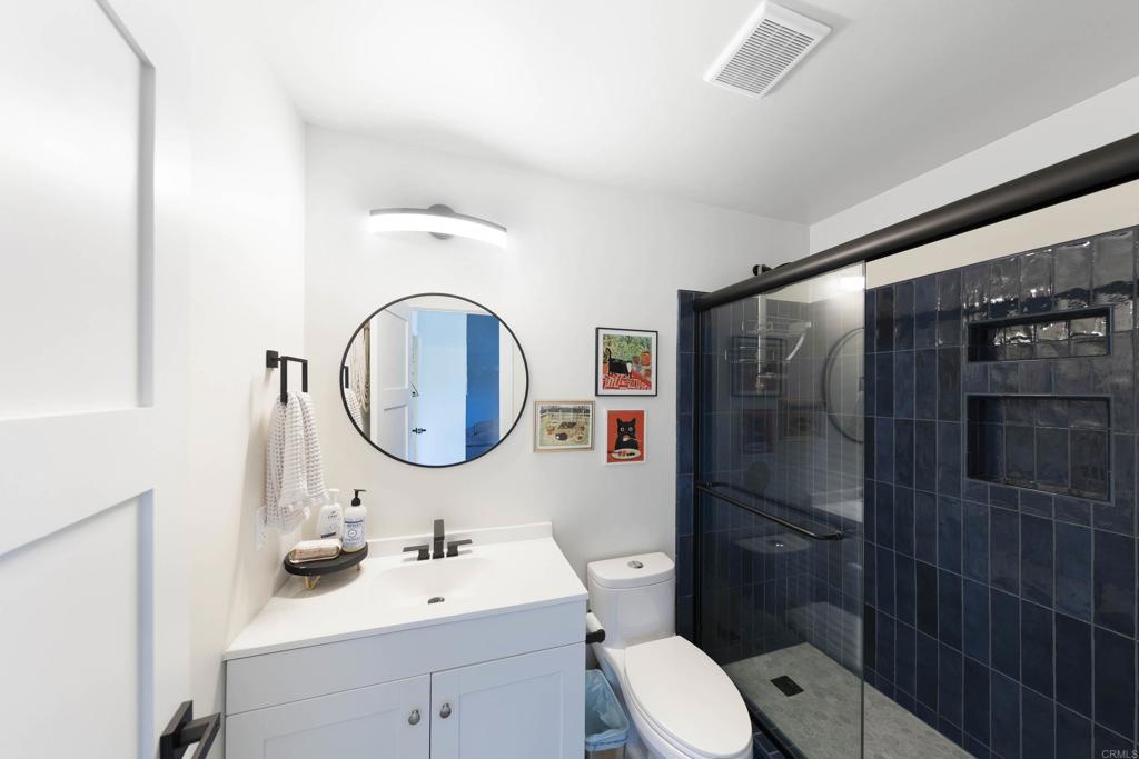 3577 Winslow Road Oceanside, CA 92056 - Photo 32 of 53 a bathroom with a toilet a sink and a mirror