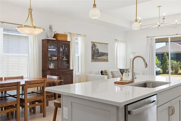 a large kitchen with cabinets table and chairs