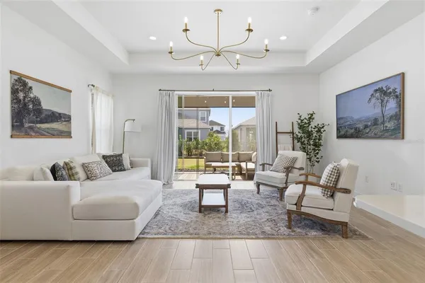 a living room with furniture and a view of kitchen