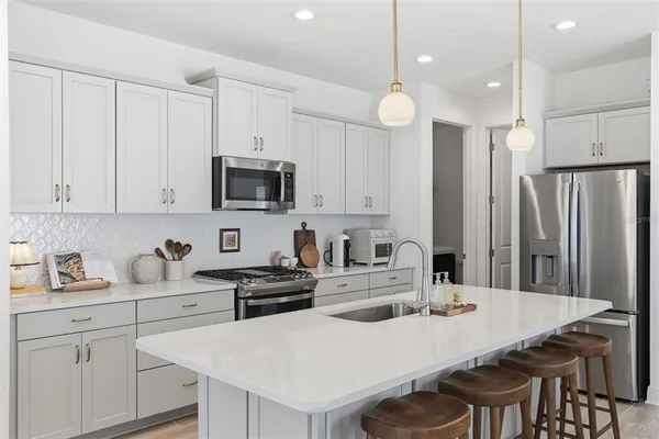 a kitchen with sink stove and cabinets