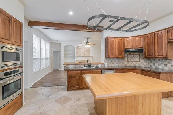 a kitchen with stainless steel appliances granite countertop a sink and cabinets