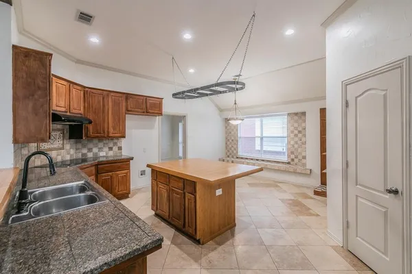 a kitchen with a stove sink and refrigerator