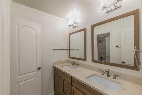 a bathroom with 2 sink and a mirror