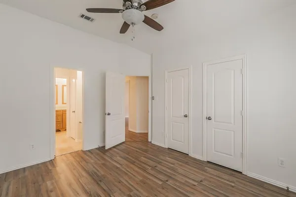 a view of an empty room and wooden floor