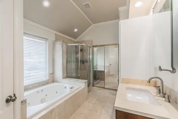 a bathroom with a tub sink and mirror