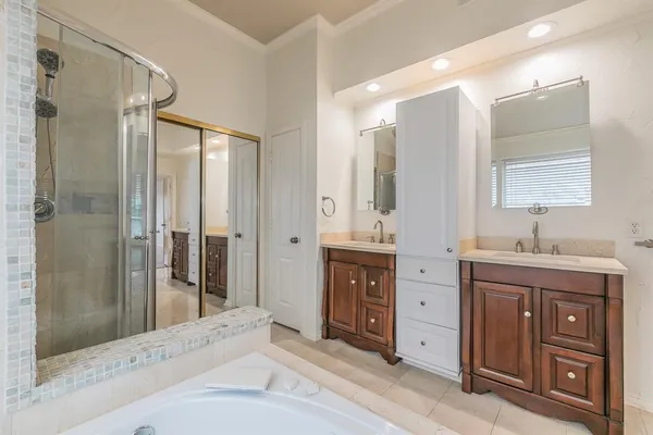 a spacious bathroom with a shower sink and mirror