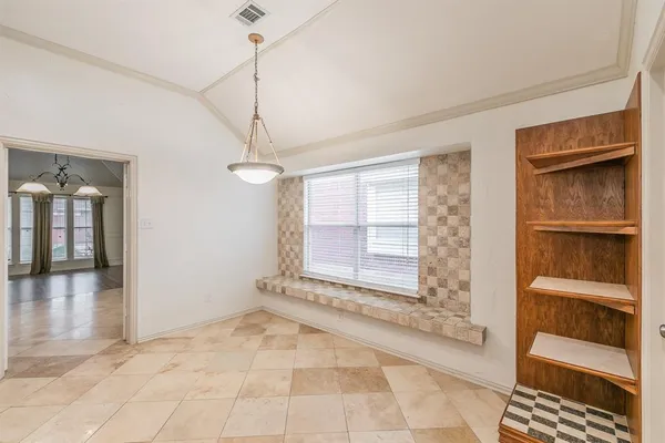 a view of an empty room with a fireplace and a window