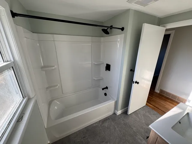 a bathroom with a tub and a shower