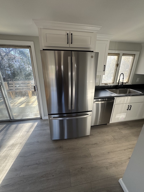8 Nicks Rock Road, Unit 1 Plymouth, MA 02360 - Photo 10 of 27 a view of a refrigerator in kitchen and wooden floor