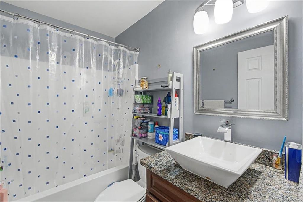 409 Windsor Way Canton, GA 30115 - Photo 24 of 51 a bathroom with a sink a toilet and a mirror