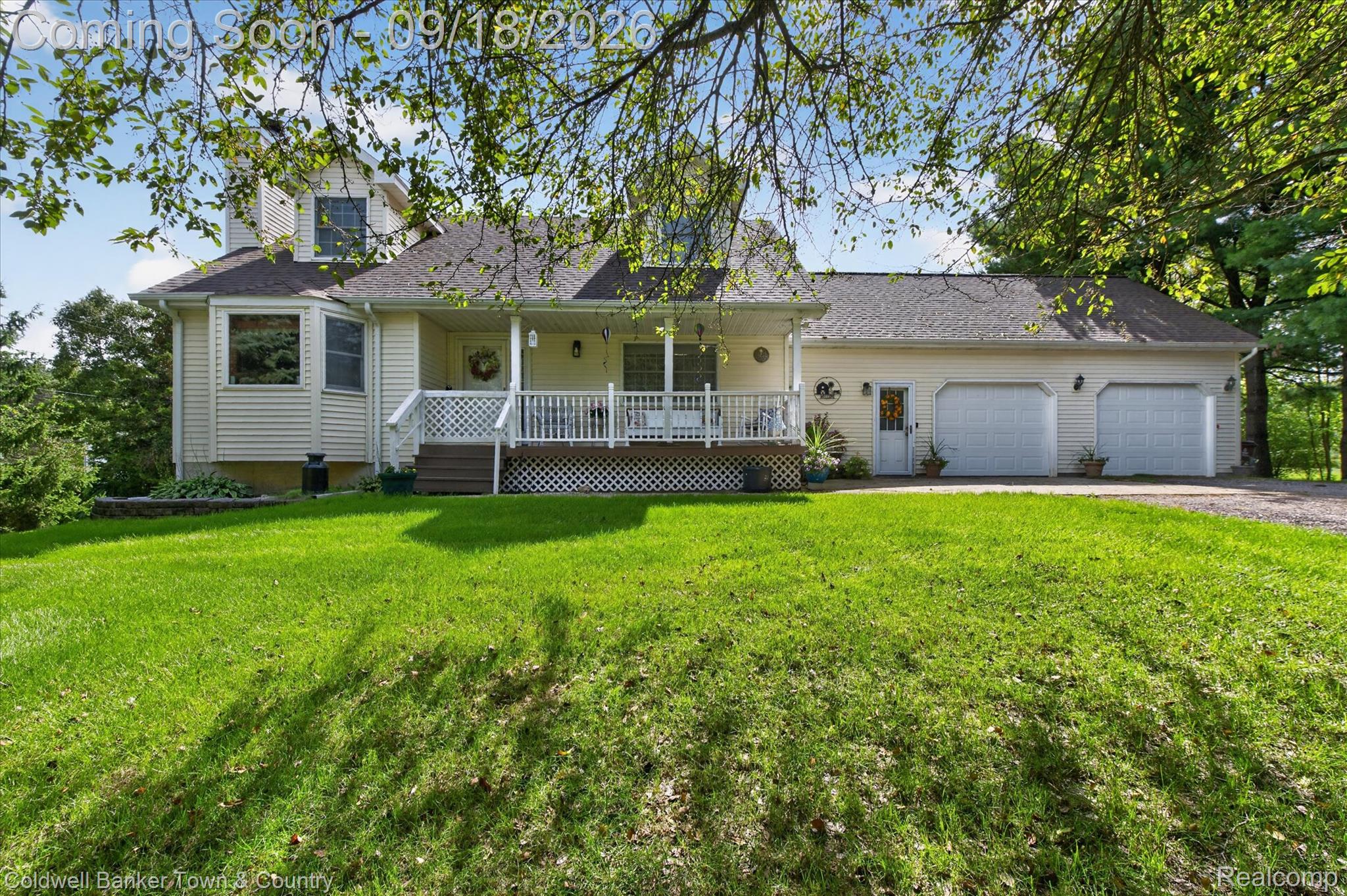 4442 McGunn Road Howell, MI 48843 - Photo 6 of 63 Exterior with light-colored siding, a covered front porch, and a two-car garage