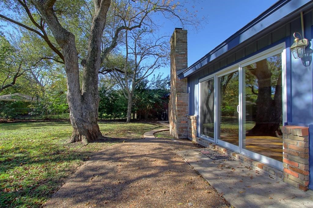 5611 Arboles Drive Houston, TX 77035 - Photo 3 of 13 a view of a house with backyard and a tree
