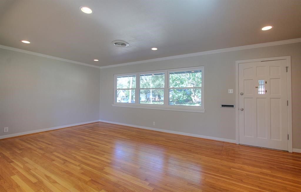 5611 Arboles Drive Houston, TX 77035 - Photo 4 of 13 an empty room with wooden floor and windows