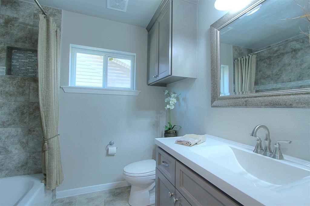 5611 Arboles Drive Houston, TX 77035 - Photo 5 of 13 a bathroom with a sink a toilet and vanity