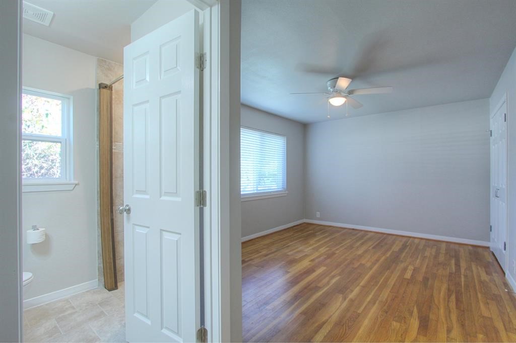 5611 Arboles Drive Houston, TX 77035 - Photo 6 of 13 an empty room with wooden floor and windows