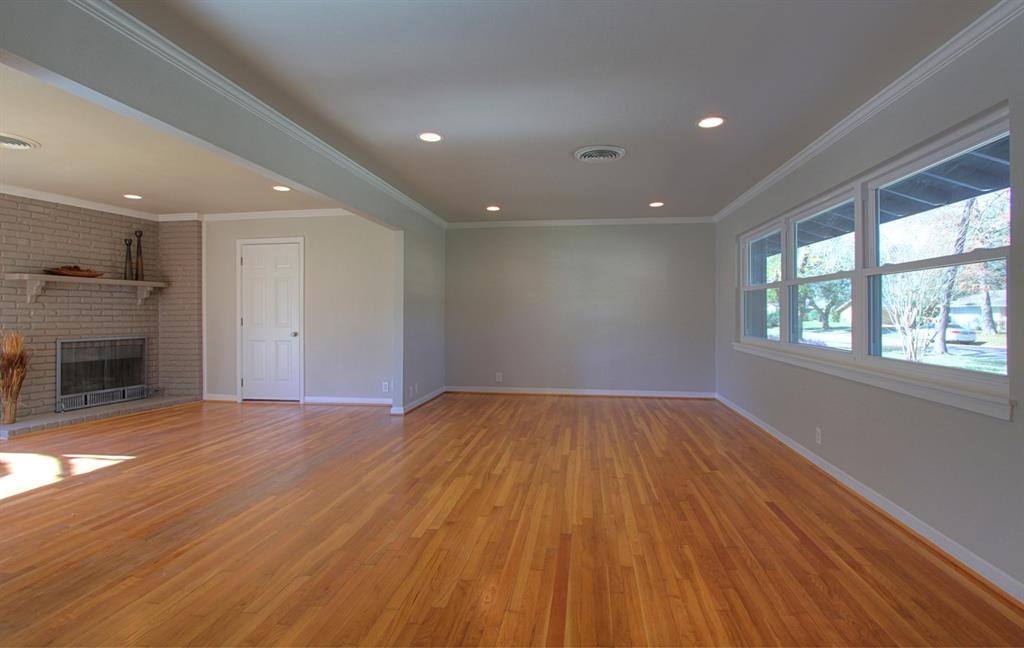 5611 Arboles Drive Houston, TX 77035 - Photo 9 of 13 a view of an empty room with a window and wooden floor