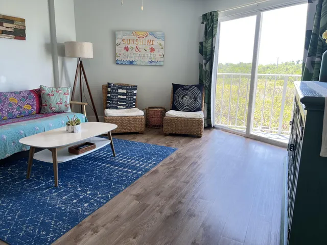 a living room with furniture and a floor to ceiling window