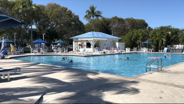 a view of a swimming pool with an outdoor seating