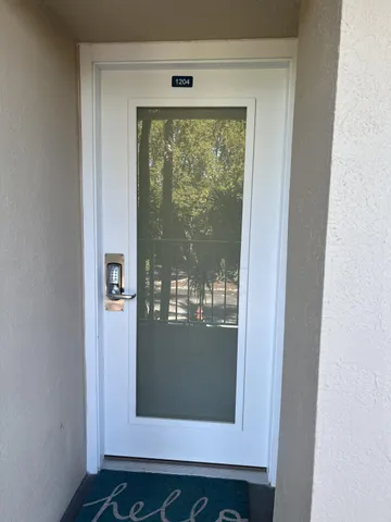 a room with pool table a rug and potted plant