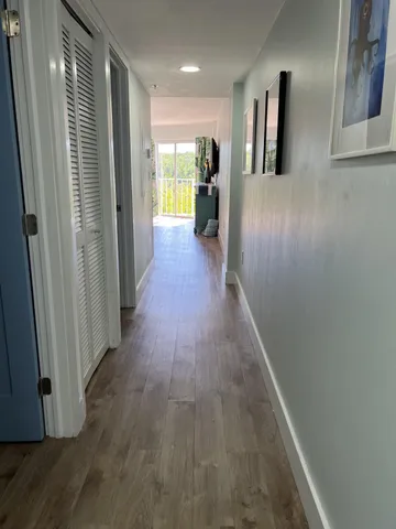 a view of hallway with wooden floor