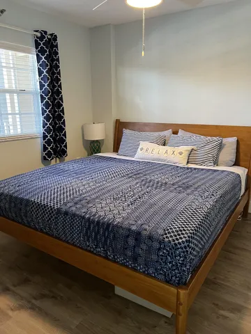 a bed sitting in a bedroom next to a window