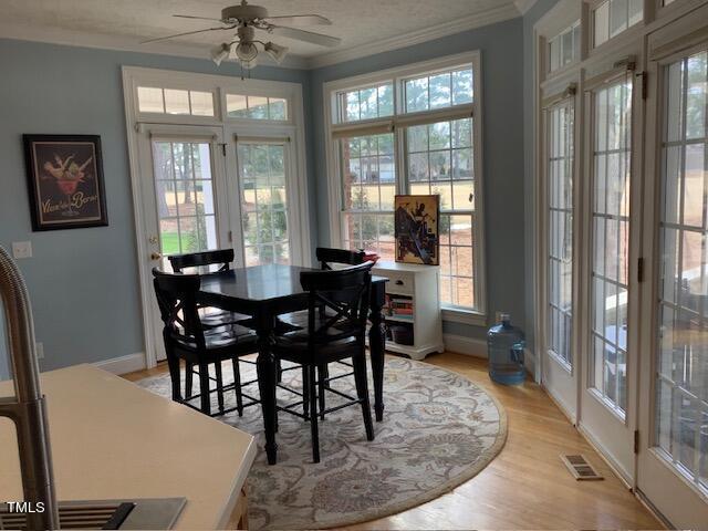 2125 Keith Hills Road Lillington, NC 27546 - Photo 14 of 66 a view of a dining room with furniture wooden floor and a chandelier