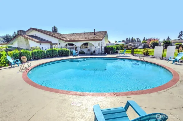 a swimming pool with outdoor seating and yard