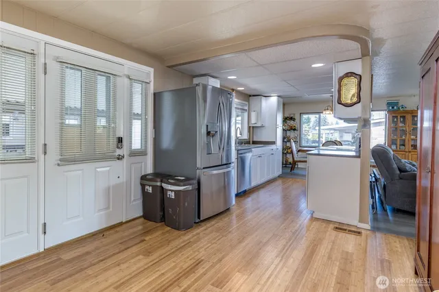 a kitchen with stainless steel appliances granite countertop a refrigerator and a stove