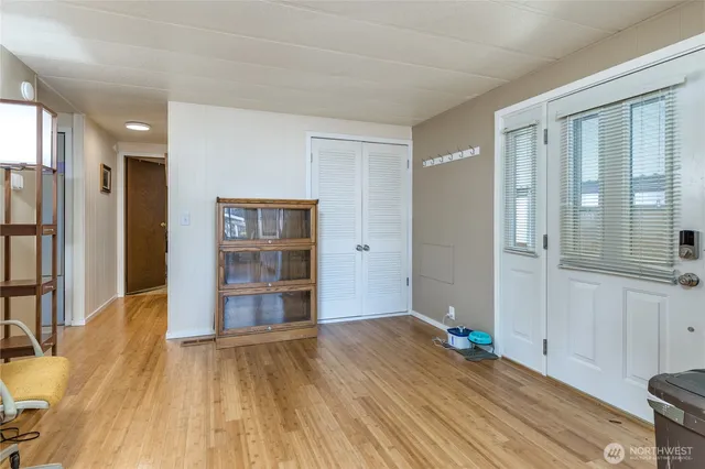 a view of empty room with a window and wooden floor