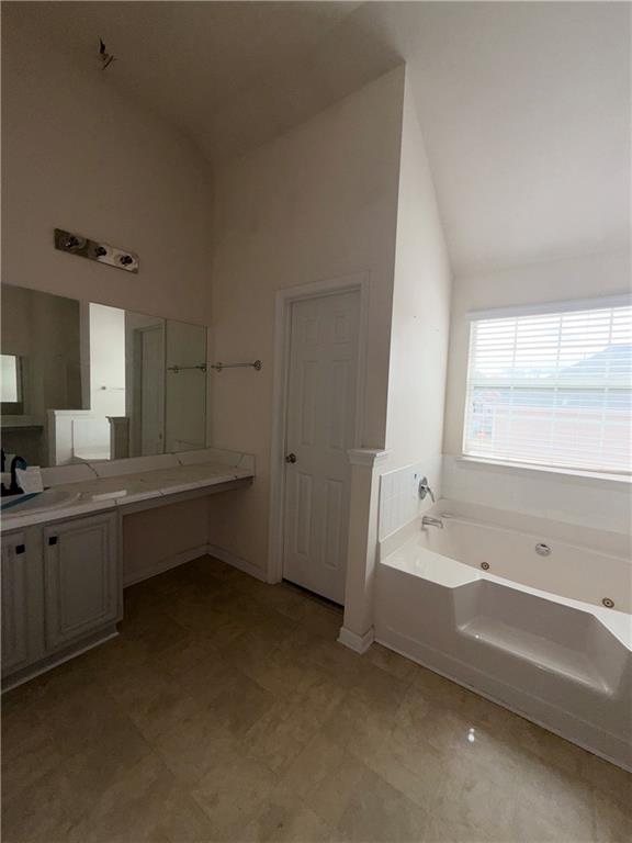 620 Superior Way Fairburn, GA 30213 - Photo 14 of 27 a bathroom with a tub a sink and a bathtub