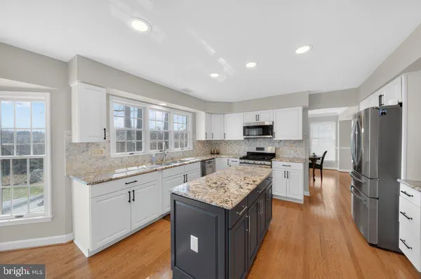 a kitchen with a sink stove and refrigerator