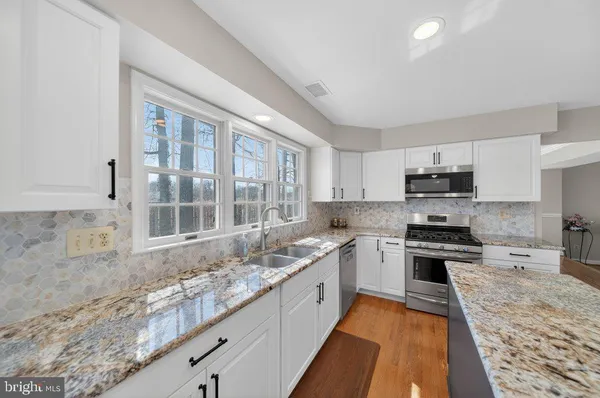 a large kitchen with a stove top oven