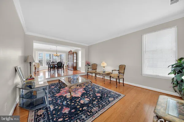 a living room with furniture a rug and a table