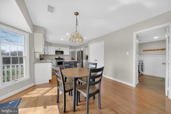 a view of a dining room with furniture window and wooden floor