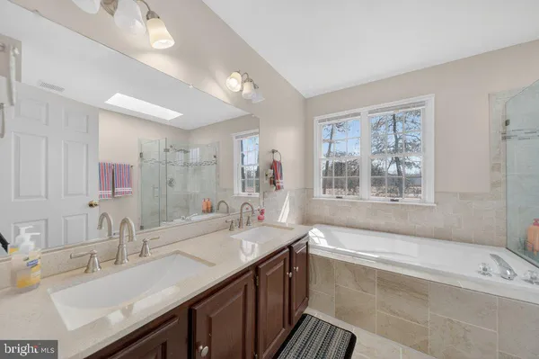 a bath room with a sink and a bath tub
