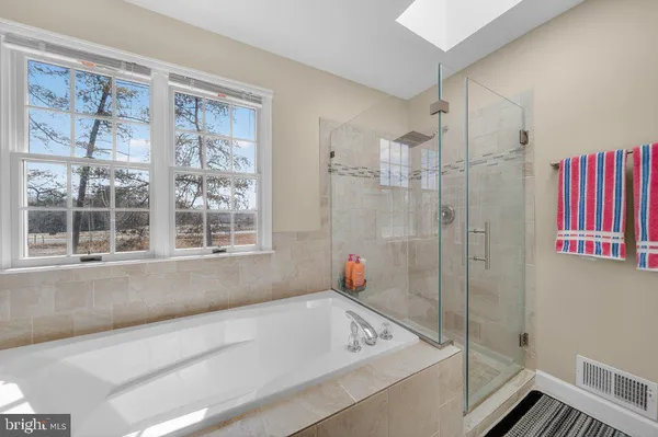 a bathroom with a tub and a window
