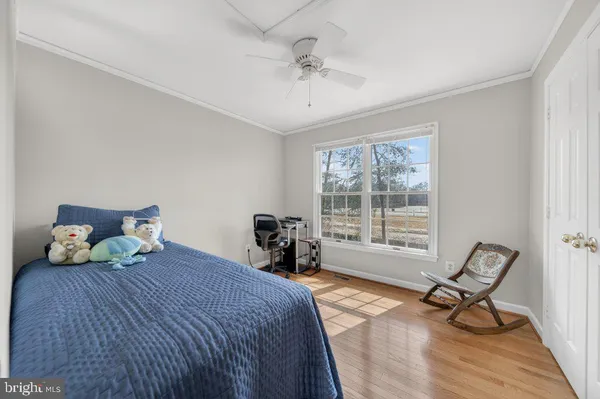 a bedroom with a bed and chair