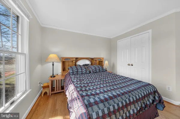 a bedroom with a bed and a large window with outer view