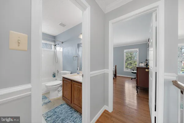 a bathroom with a toilet sink and a mirror