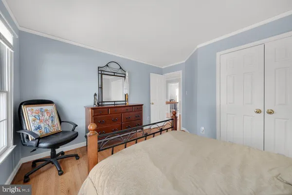 a bedroom with a bed and a mirror