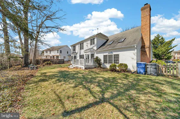 a view of a house with a large tree in front of it