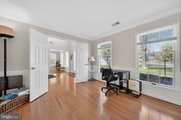 a view of a livingroom with workspace and a window