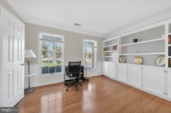 a view of work space with furniture and windows