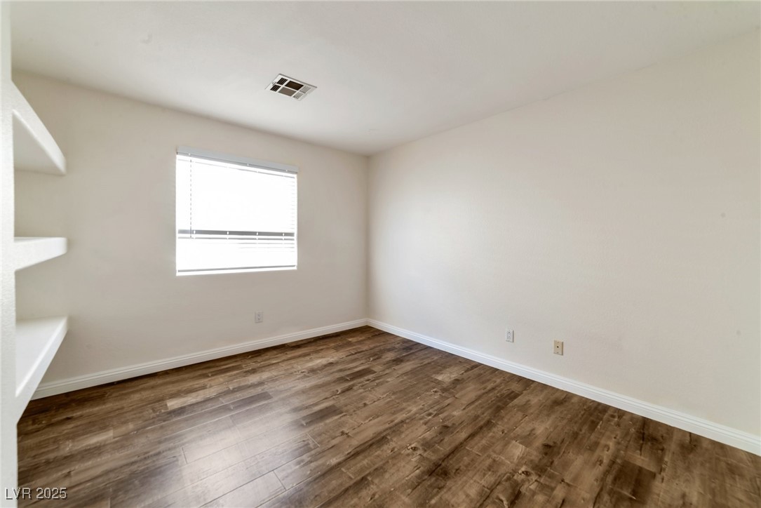 121 Golf Course Street Las Vegas, NV 89145 - Photo 6 of 15 Spare room with visible vents, baseboards, and wood finished floors