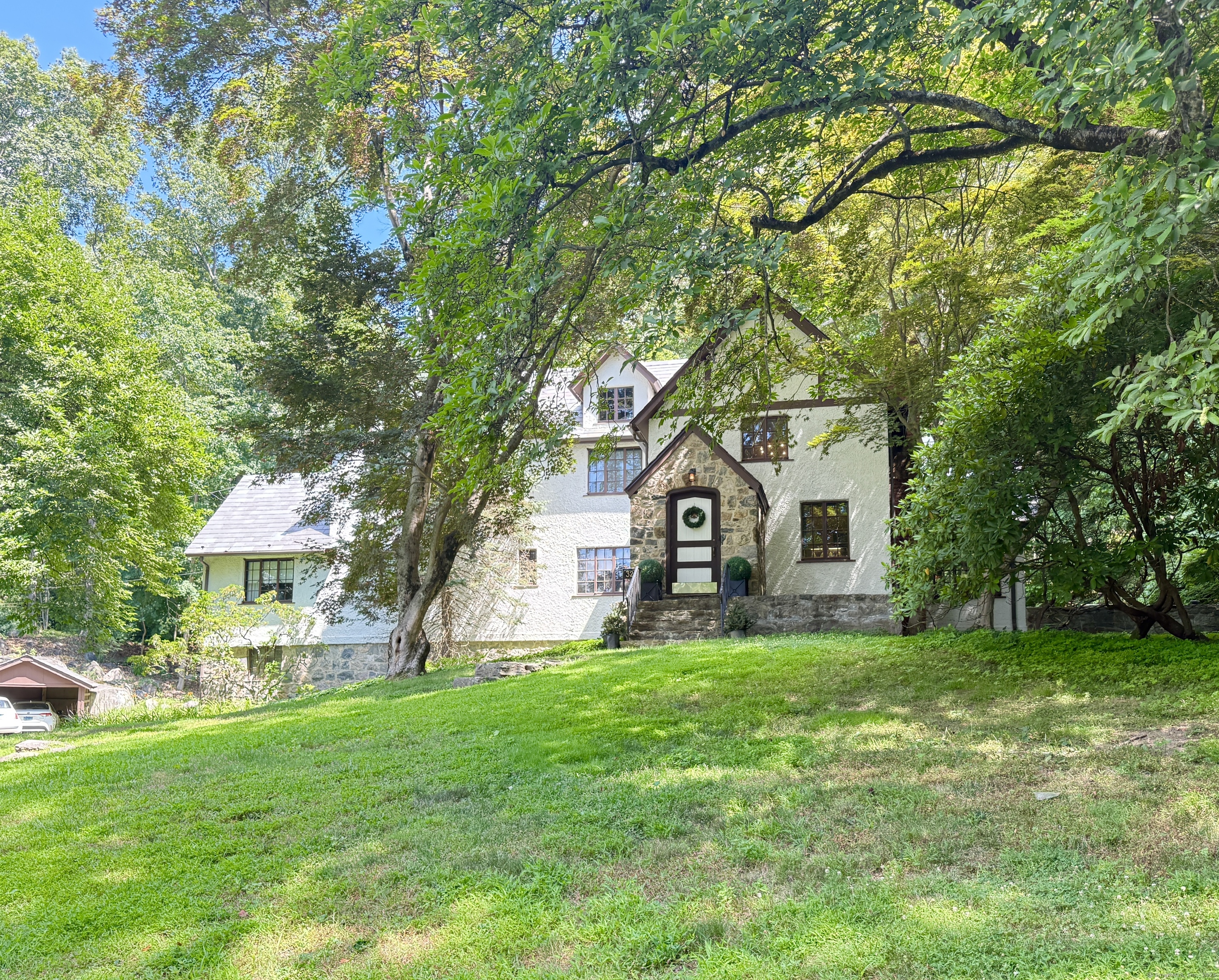 a front view of a house with yard and green space