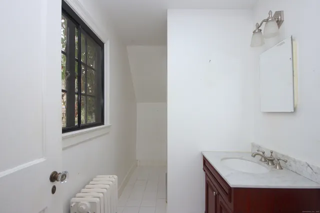 a bathroom with a sink vanity and a mirror