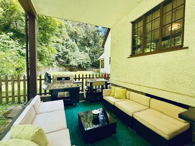 a balcony with furniture and a potted plant