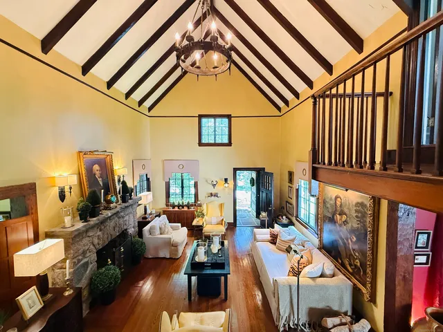 a view of a living room with furniture and floor to ceiling windows