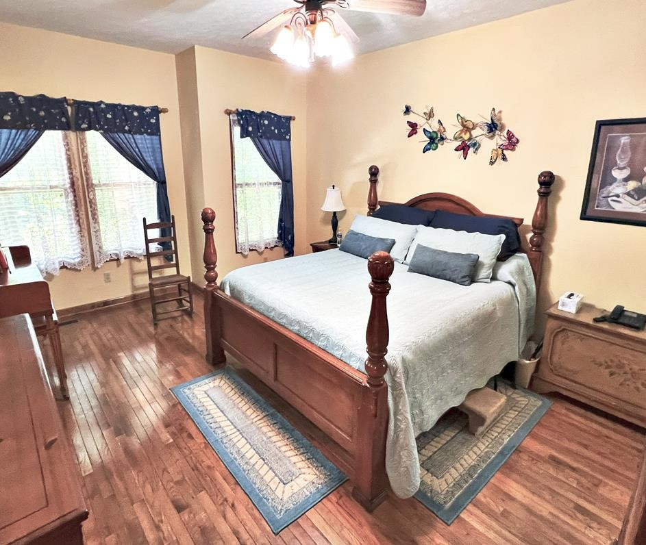 795 Lost Creek Boat Dock Road Decaturville, TN 38329 - Photo 12 of 34 a bedroom with bed and wooden floor