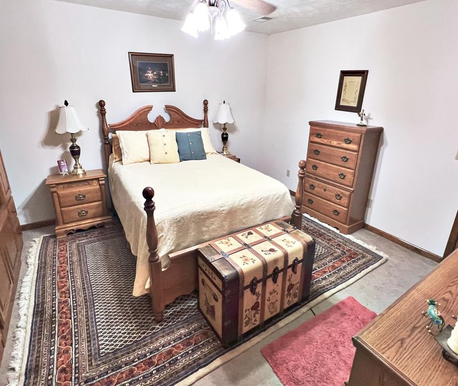 795 Lost Creek Boat Dock Road Decaturville, TN 38329 - Photo 14 of 34 a bedroom with furniture and wooden floor